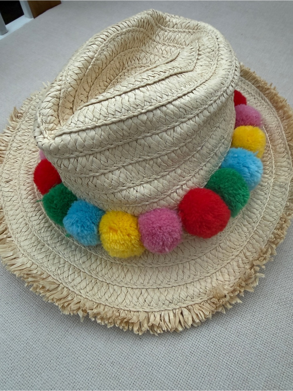 Mini Boden Straw Hat with Red, Pink, Yellow, Green and Blue Pom-Poms - Picture 1 of 3